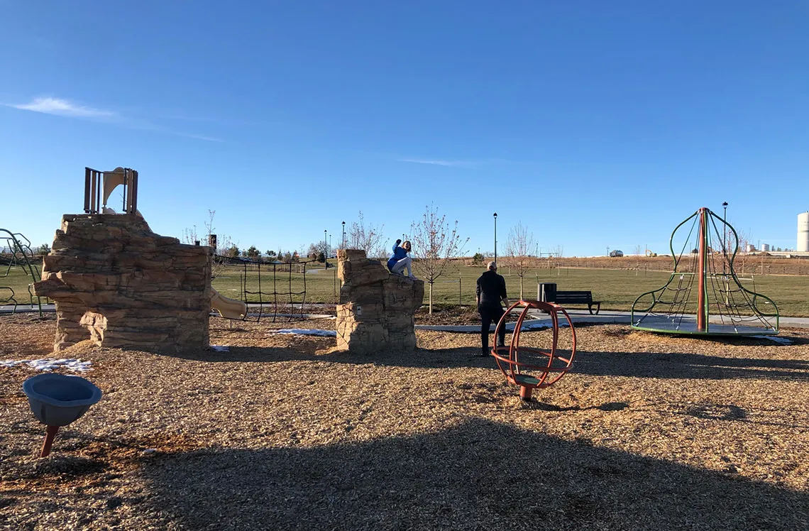 Park and playground build around rock climber structure at Talon Point at Todd Creek